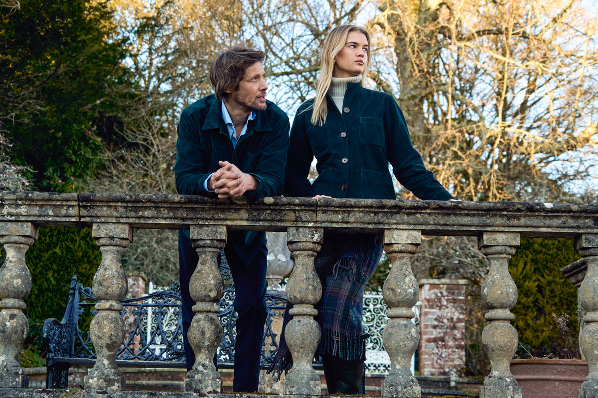 Two models wearing Everett cord utility jackets on a stone terrace